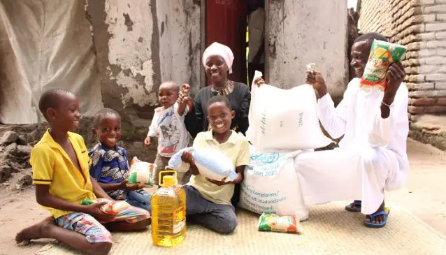 A family in Malawi overjoyed as they unpack their Ramadan food pack provided by Islamic Relief