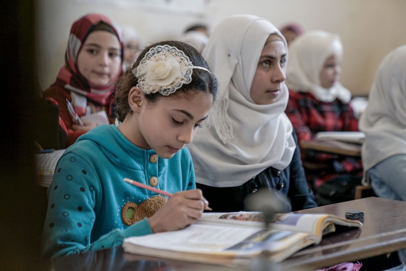 Girls in a classroom supported by Islamic Relief, studying and learning together